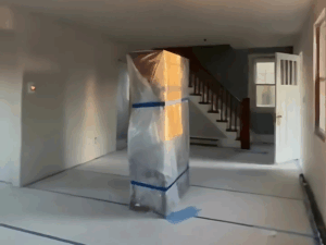 Image showing the progress of custom metal framing installation in a residential interior, with floors and structures protected for renovation.