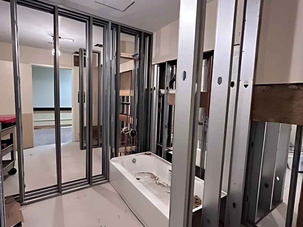 Metal Framing for Bathroom Renovation with installed bathtub and structured wall framing.