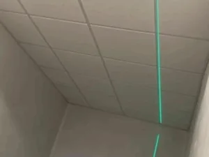 Ceiling grid structure with laser alignment tool guiding the installation