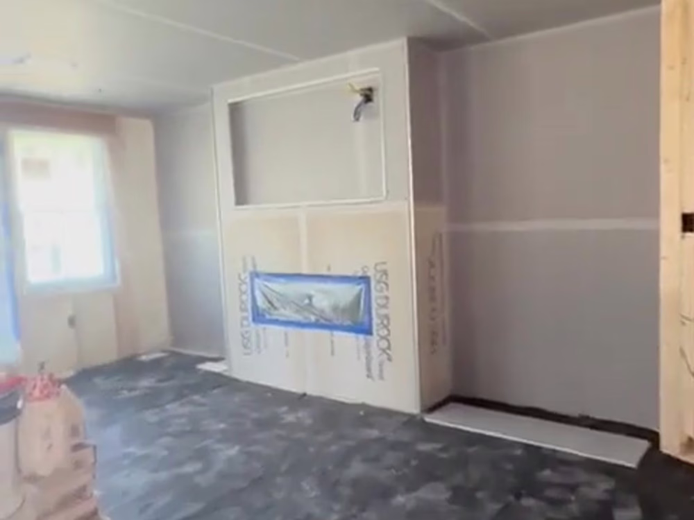Interior wall under renovation showing finish plastering work in progress