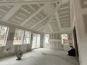 Drywall installation for custom ceiling with intricate design patterns.