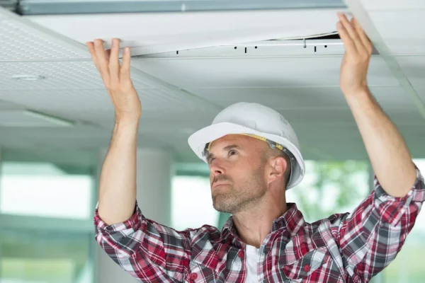 Man-installing-suspended-ceiling